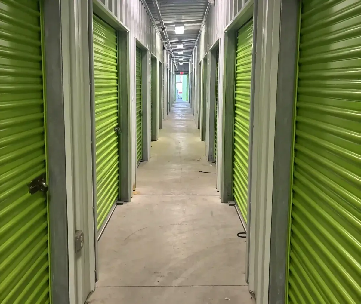 Exterior of indoor green storage units at Mountain Vista North Mini Storage.