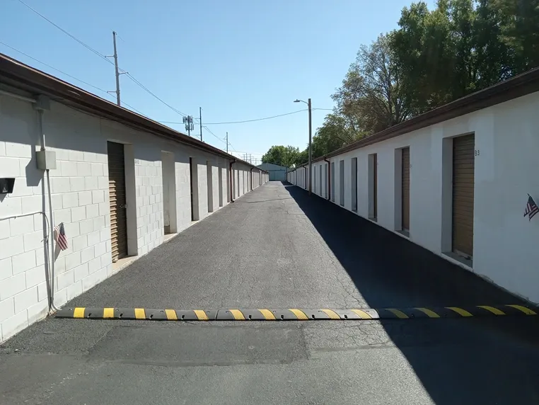 Units on both sides of wide aisle at Federal Storage featuring speed bump