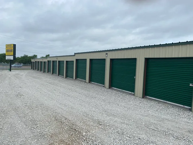 Wide drive aisle and rows of roll-up storage units at Rio Vista Mini Storage.