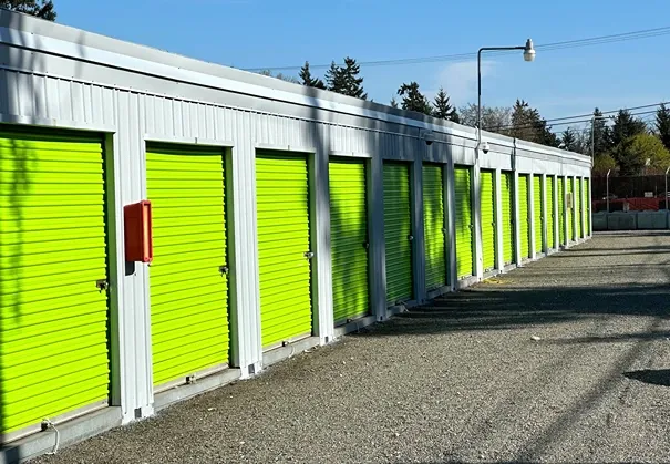 Drive-up storage units with metal roll-up doors at Sales Road Storage facility.