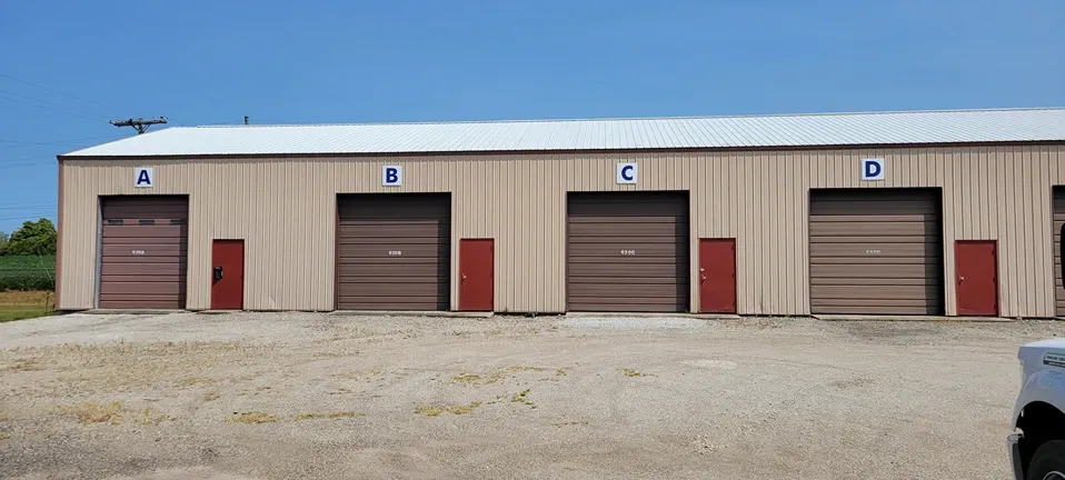 Clean roll-up doors and bright exterior at Storage Crib.