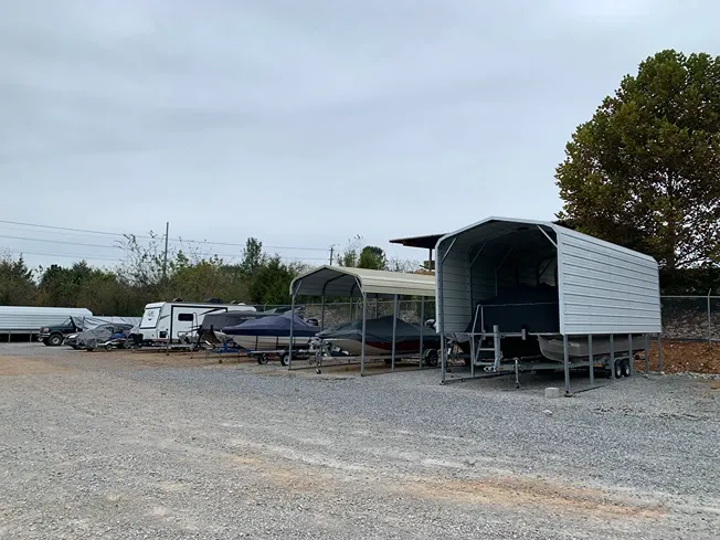 Clean gravel lanes and unit rows in front of vehicle storage at Volunteer Storage Tellico Village.