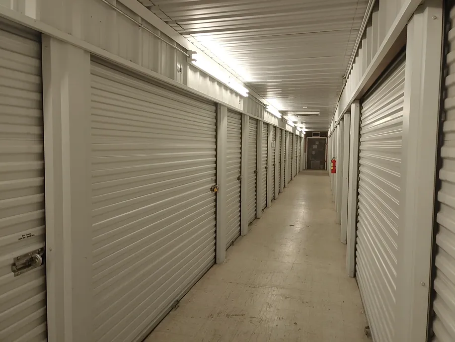 Interior corridor of storage units with polished floors at Town and Country Self Storage.