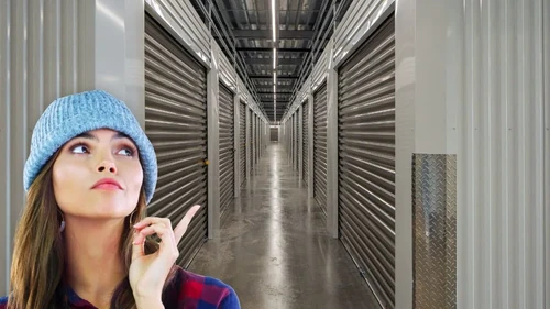 Woman pointing at a row of storage units. 